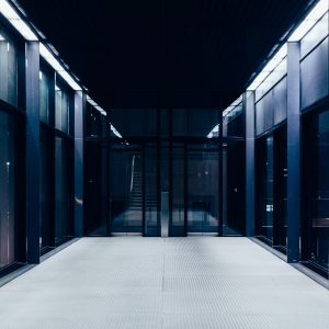 a long hallway with glass doors leading to another room